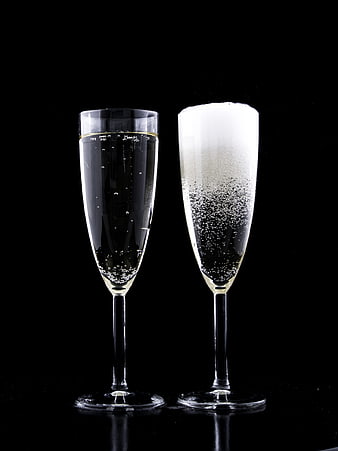 Two Champagne Flutes with Bubbles on Black Background