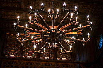 Ornate wooden chandelier with candle-style bulbs