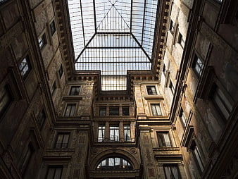 Low angle view of ornate historic courtyard with glass roof