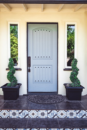 Symmetrical Blue Front Door with Spiral Topiaries