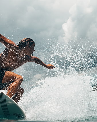 Male Surfer Riding Wave with Water Splash