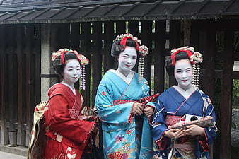 Three Japanese Maiko in Traditional Kimono and White Makeup