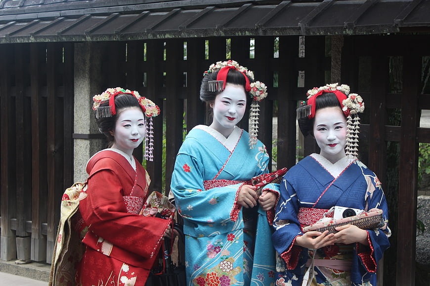Three Japanese Maiko in Traditional Kimono and White Makeup
