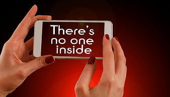 Hands holding smartphone displaying text There's no one inside on red background