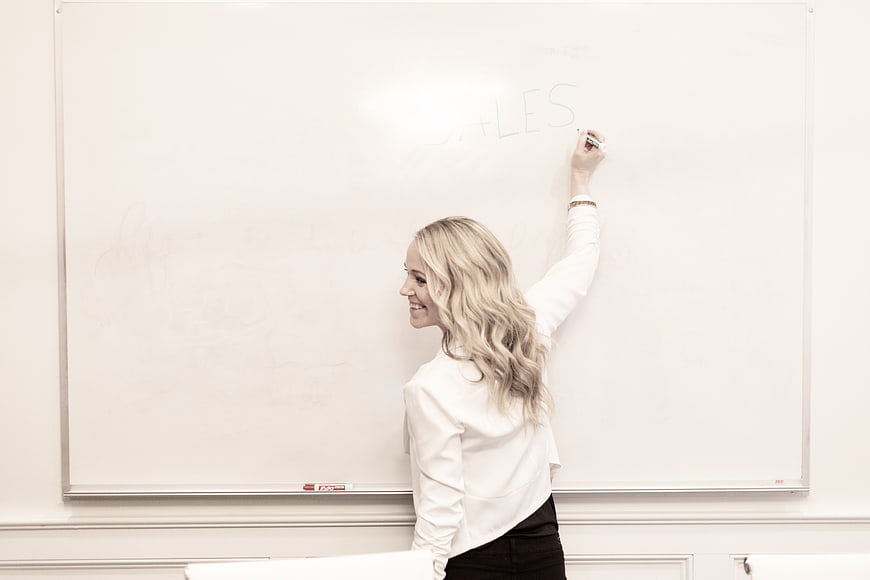 Smiling Business Woman Writing on Whiteboard