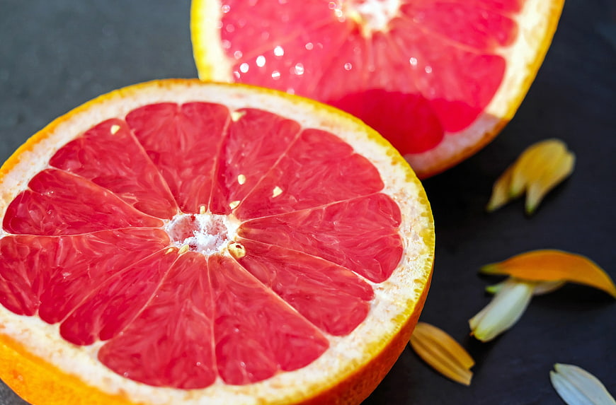 Fresh Red Grapefruit Slices on Dark Background