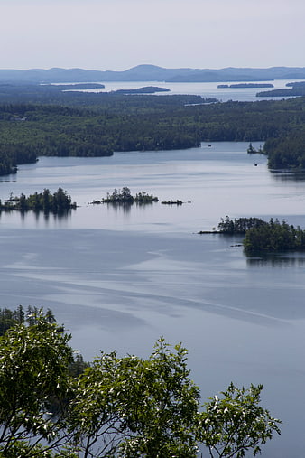 Scenic Lake Landscape with Forested Islands and Distant Mountains