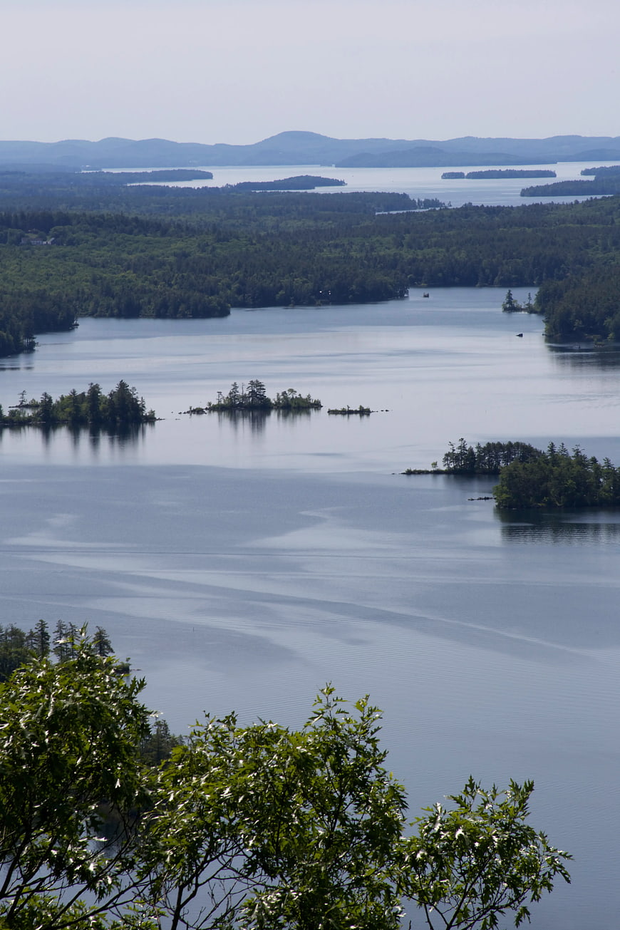 Scenic Lake Landscape with Forested Islands and Distant Mountains