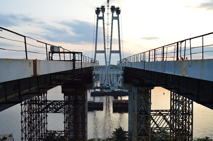 Symmetrical view of a drawbridge opening over a river at sunset