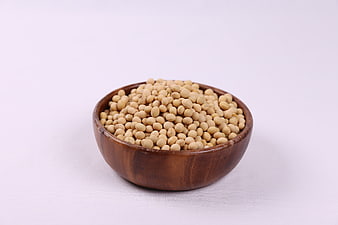 Wooden Bowl of Raw Soybeans on White Background