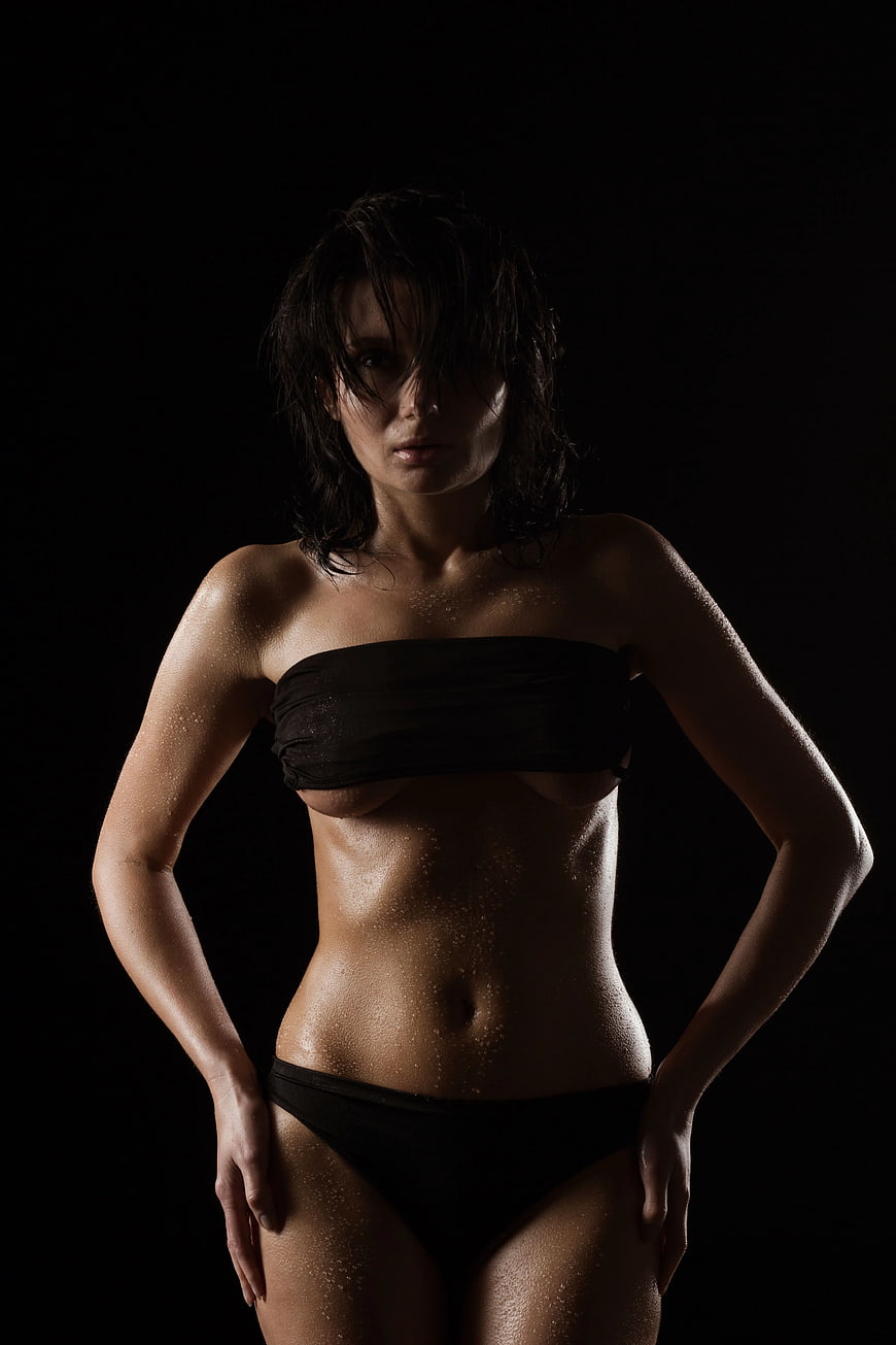 Sensual Woman in Black Bikini with Wet Skin