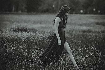 Woman in Dress Walking Through Grassy Field