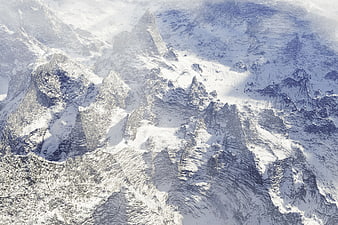 Aerial View of Snow-Covered Mountain Peaks in Winter