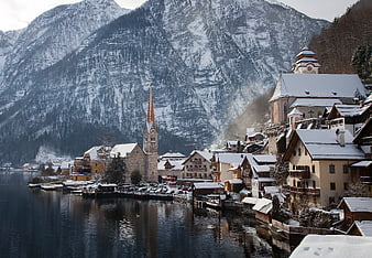 Snowy Hallstatt Village with Church and Mountain Reflections