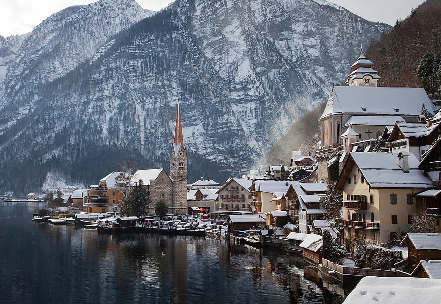 Snowy Hallstatt Village with Church and Mountain Reflections