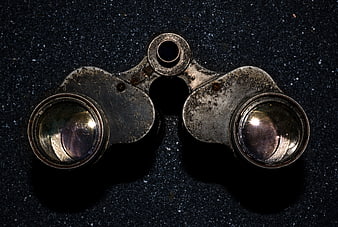 Antique brass opera glasses on dark textured background