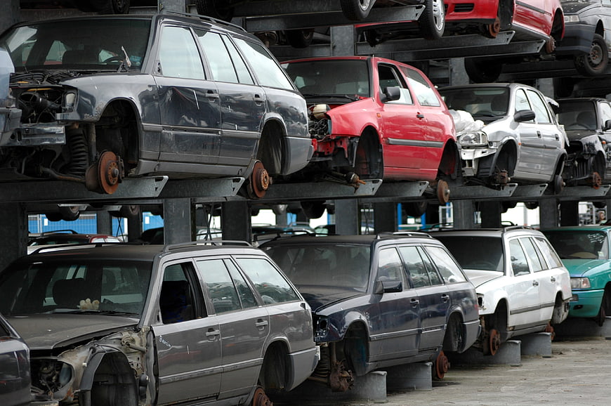 Stacked damaged cars in auto salvage yard