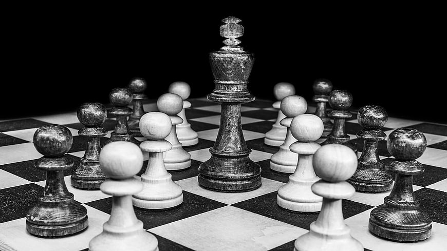 Black and white chess pieces on a checkered board