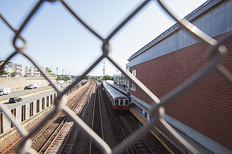 Train station view through chain link fence