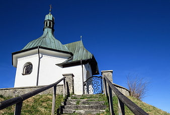 White Chapel with Green Roof on Hillside