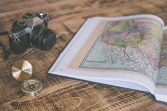 Vintage Camera, Compass, and Map on Wooden Table