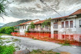 Abandoned industrial building with orange safety fence