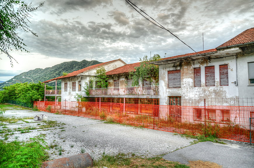 Abandoned industrial building with orange safety fence