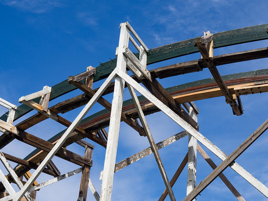 Wooden Rollercoaster Tracks Against Blue Sky