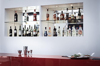 Modern Home Bar Setup With Glass Shelves And Red Counter
