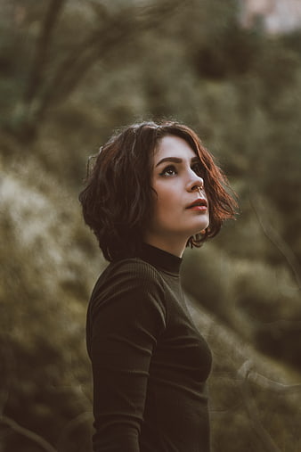 Contemplative Woman with Short Hair in Forest