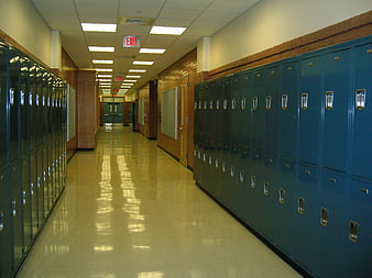 Empty school hallway with blue lockers and shiny floor