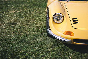Close-up of yellow vintage car on grass
