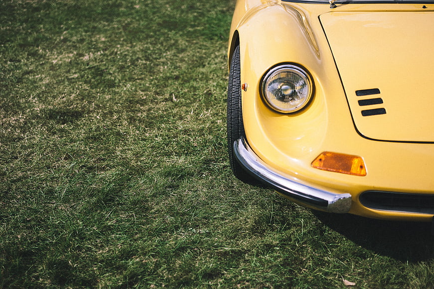 Close-up of yellow vintage car on grass