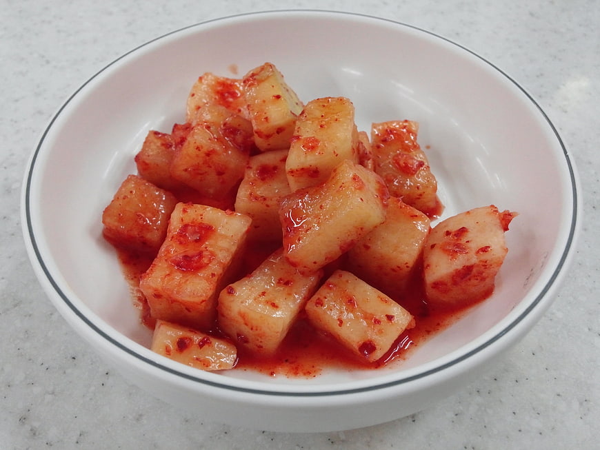 Cubed Radish Kimchi in White Ceramic Bowl