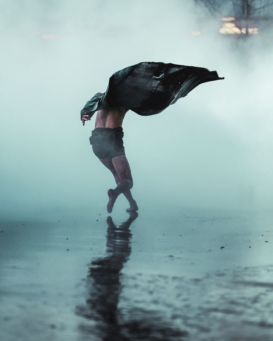 Man Running in Fog with Jacket Over Head