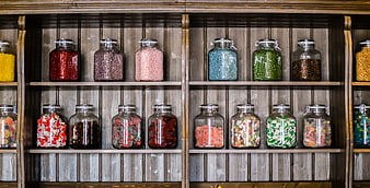 Colorful candy jars on wooden shelves in a sweet shop