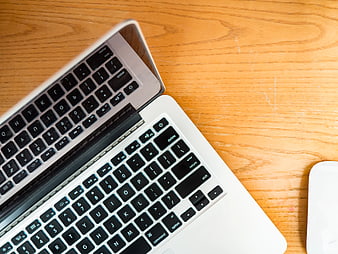 Top View of Open Laptop Keyboard on Wooden Desk