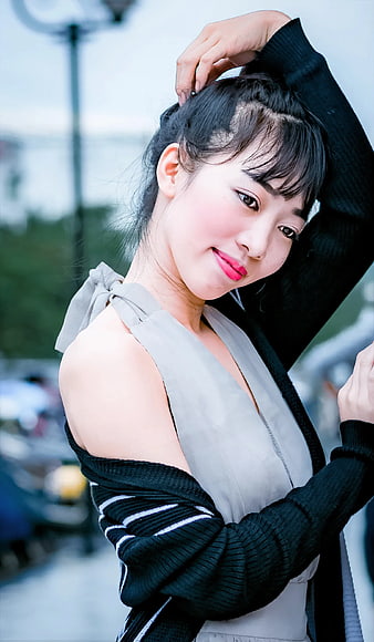 Young Woman in Gray Dress and Black Cardigan