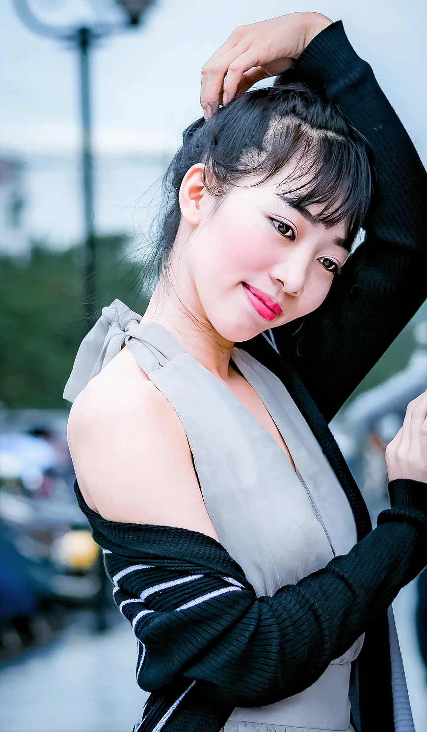 Young Woman in Gray Dress and Black Cardigan