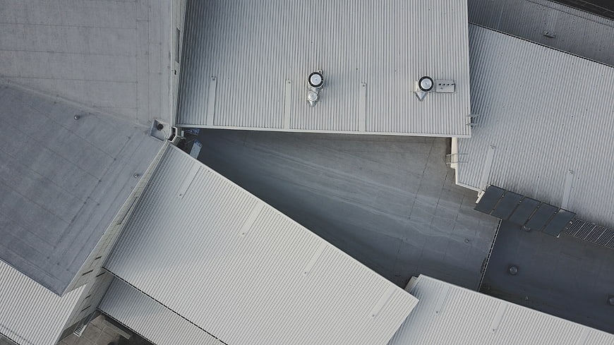 Aerial view of industrial warehouse roofs with ventilation units
