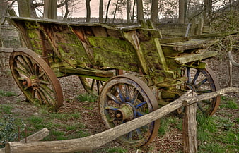 Weathered antique wooden farm cart in rustic countryside