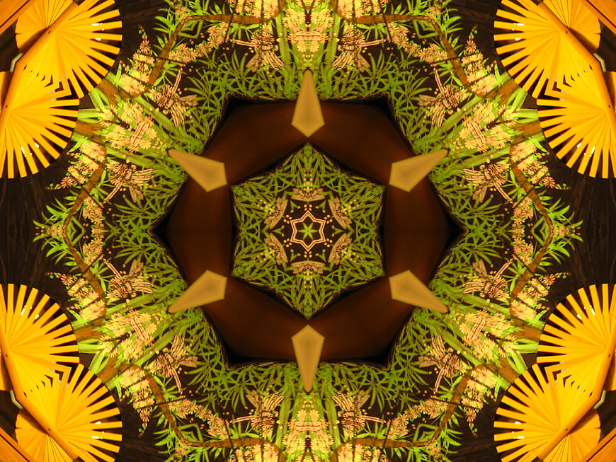 Abstract kaleidoscope pattern with green leaves and yellow fans