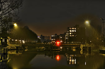 Night View of Canal Bridge with City Lights and Reflections
