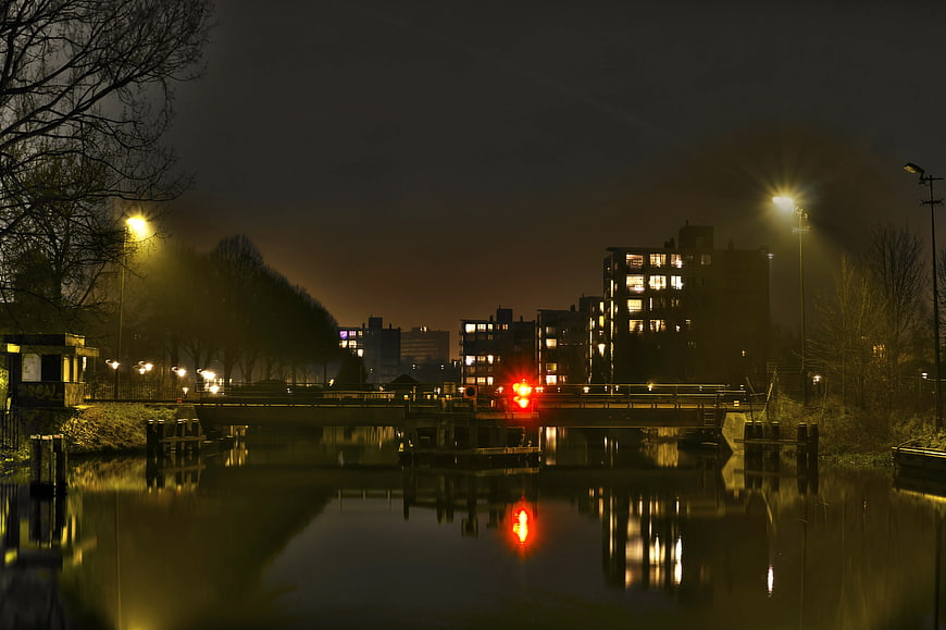 Night View of Canal Bridge with City Lights and Reflections