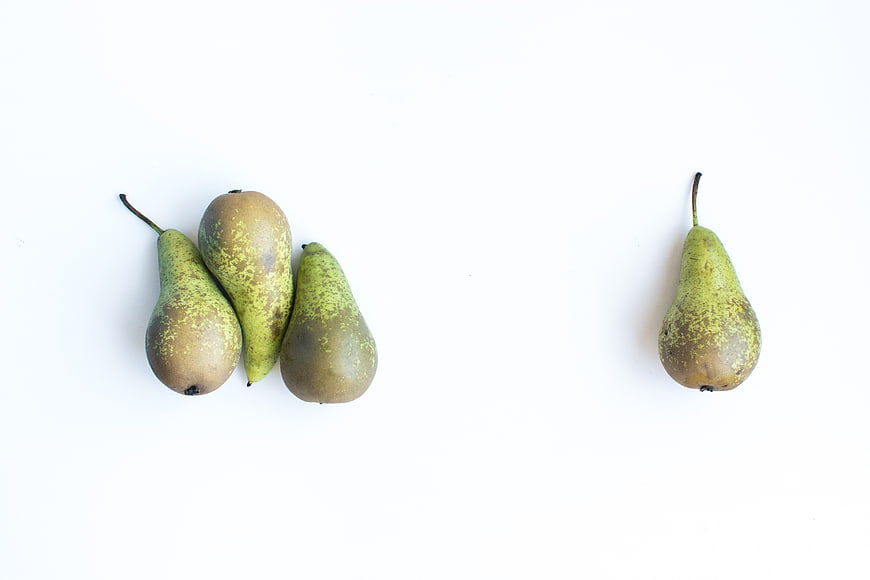 Fresh green pears on white background top view