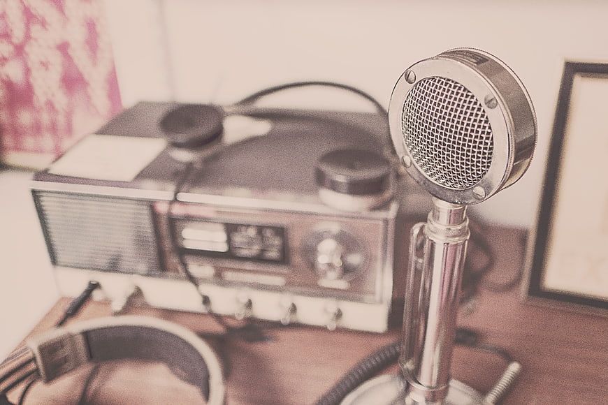 Vintage Microphone and Retro Radio on Wooden Desk