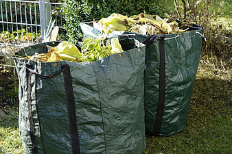 Green Garden Waste Bags Filled With Leaves And Branches