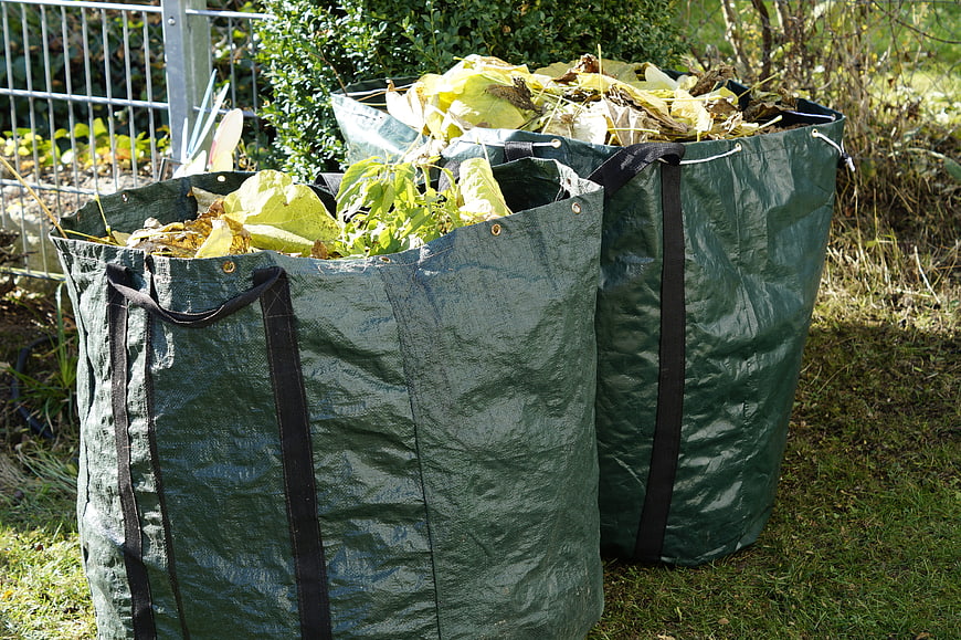 Green Garden Waste Bags Filled With Leaves And Branches