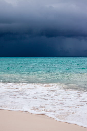 Dramatic Storm Clouds Over Turquoise Caribbean Beach Waves