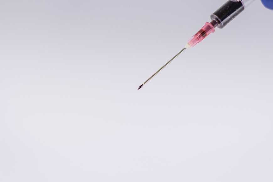 Close-up of a medical syringe needle against a clean white background